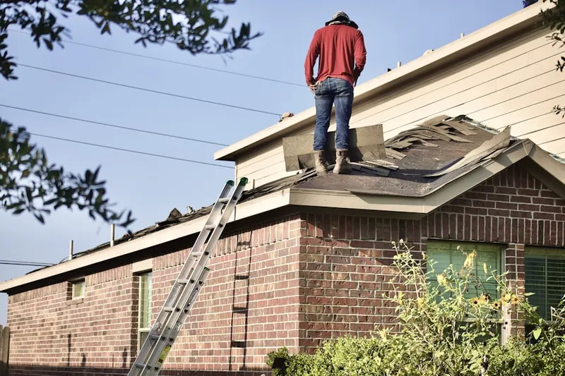 Professional roofer working on a residential roof in Morgan